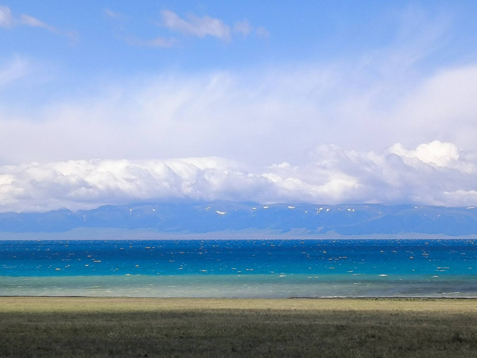 Sayram Lake under snow-capped mountains